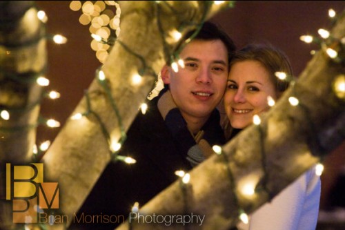 wheaton engagement session photography - behind a tree with christmas lights