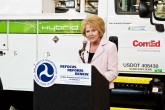 speaker at podium truck in background